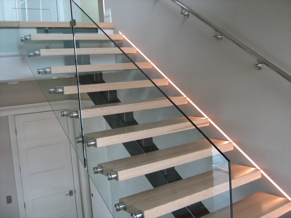 Integrated lighting beside a glass-sided staircase